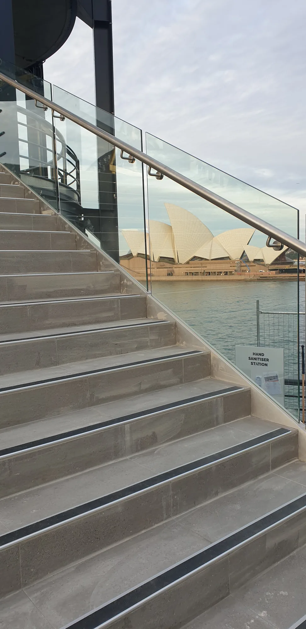 Frameless glass balustrade on a coastal deck and stair with ocean views.