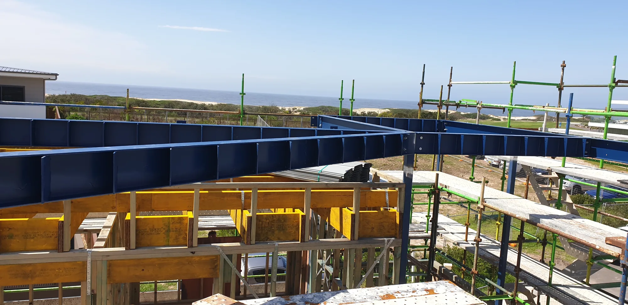 Structural steel floor framing on a hillside new build with ocean views.